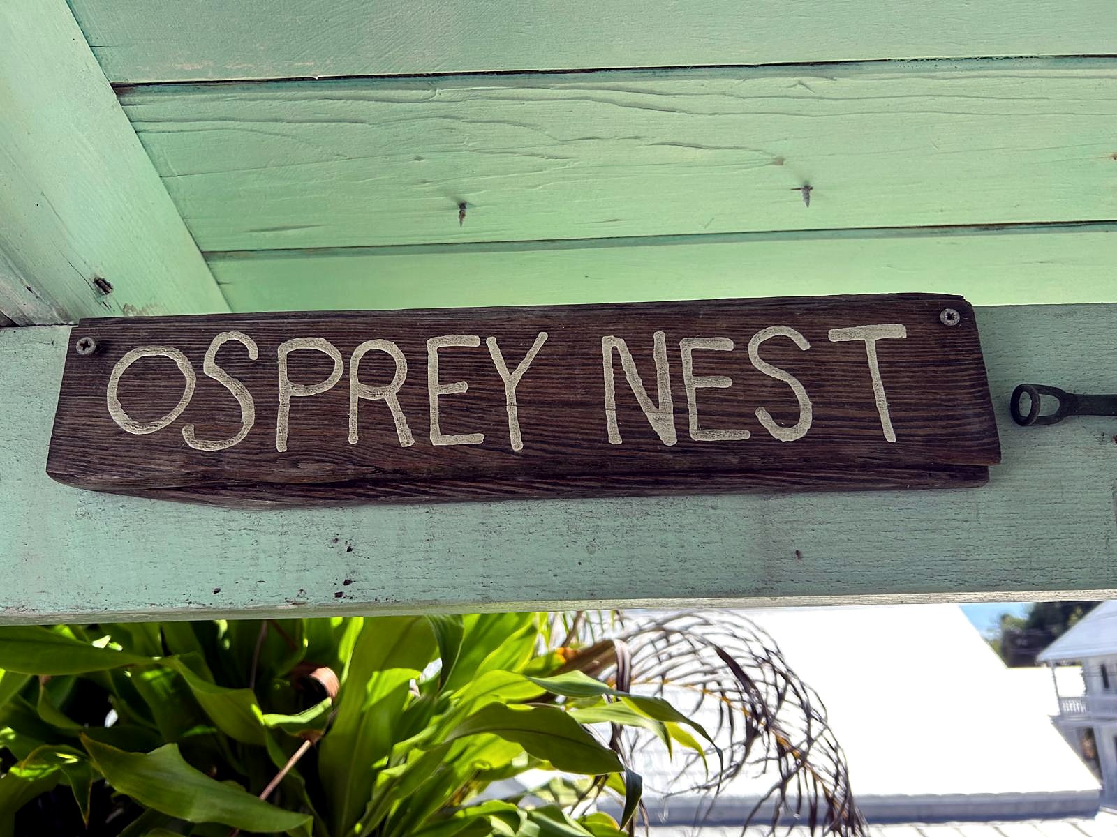 Hand-carved Osprey Nest sign on the studio above Ros’s home in Key West