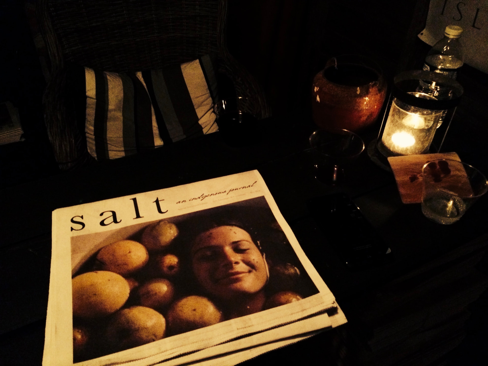 A copy of salt: an indigenous journal on a table by candlelight