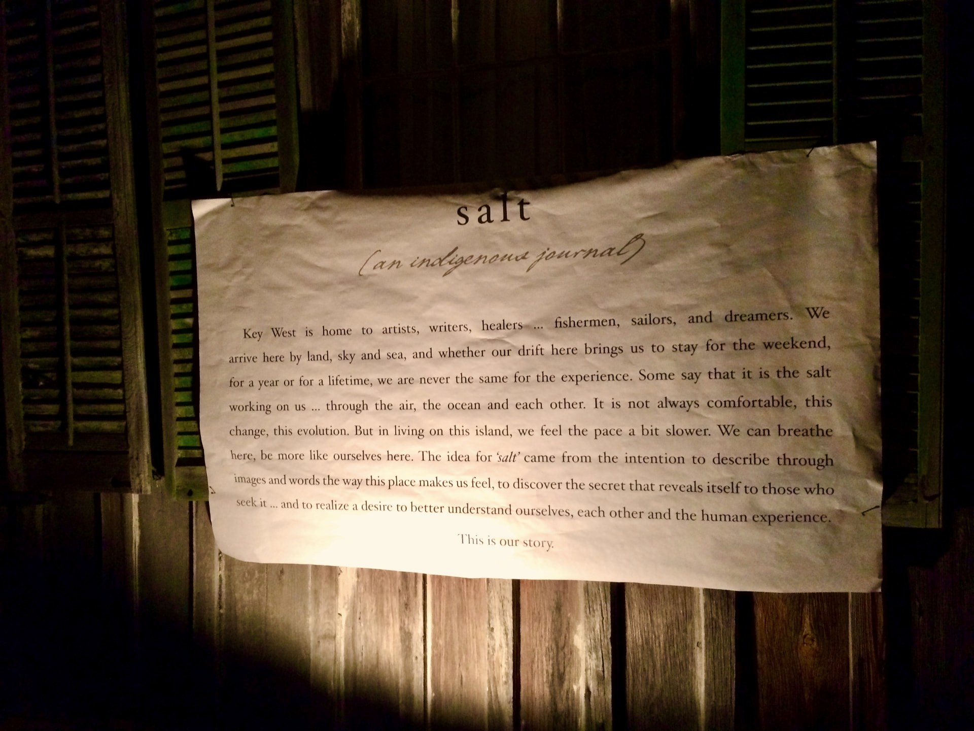 The salt broadsheet, pinned to weathered wooden shutters at night, ending with the words This is our story
