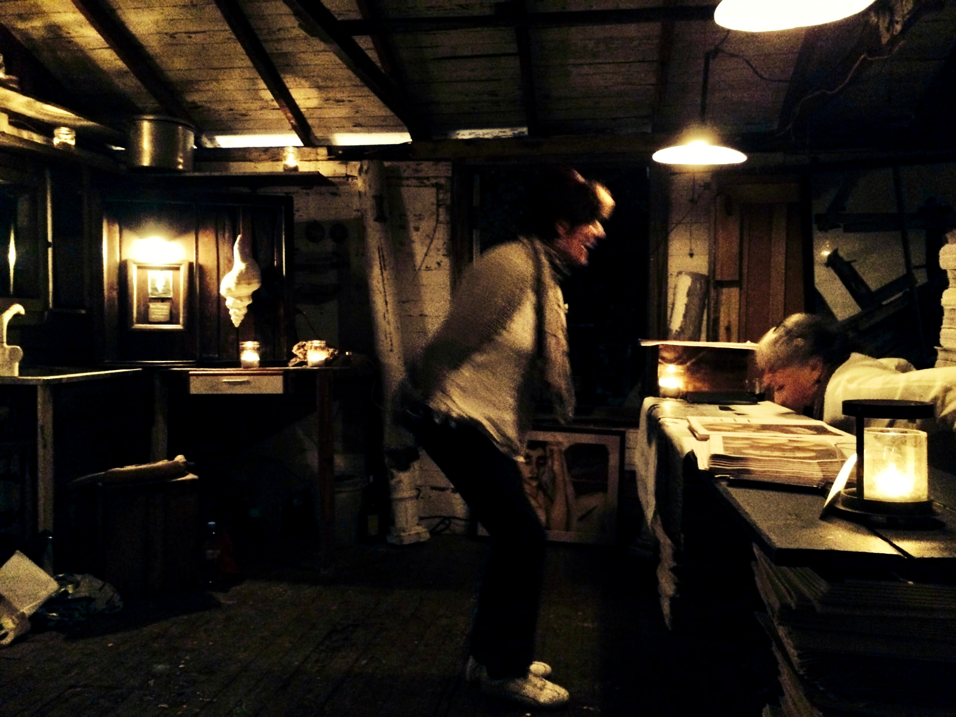 Ros laughing and leaning toward Dianne Zolotow across a candlelit table