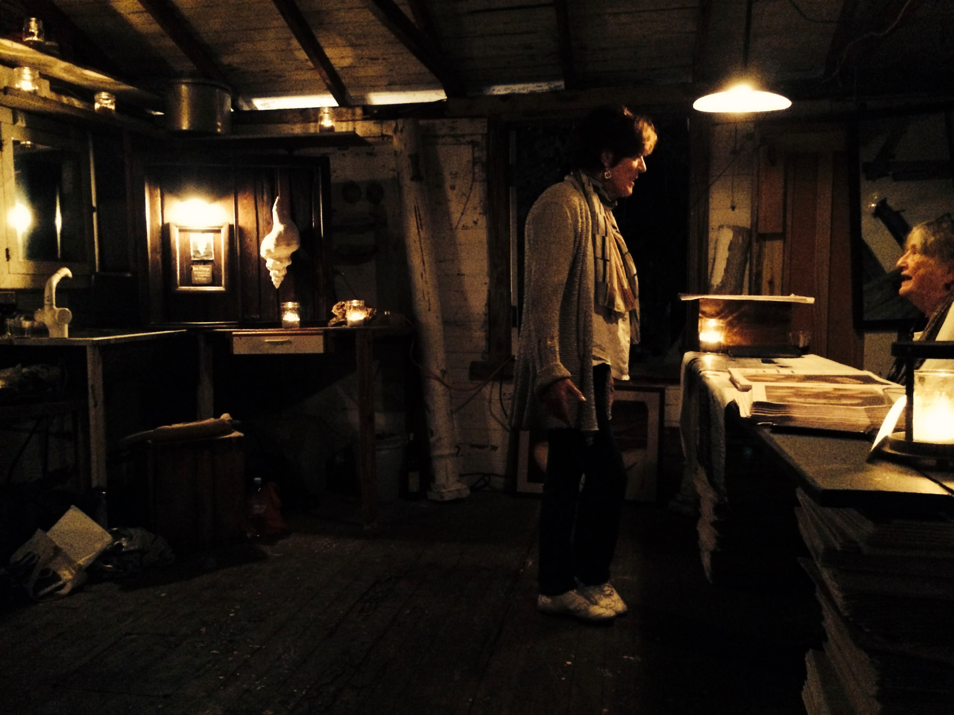 Ros talking with Dianne Zolotow in a candlelit wooden room